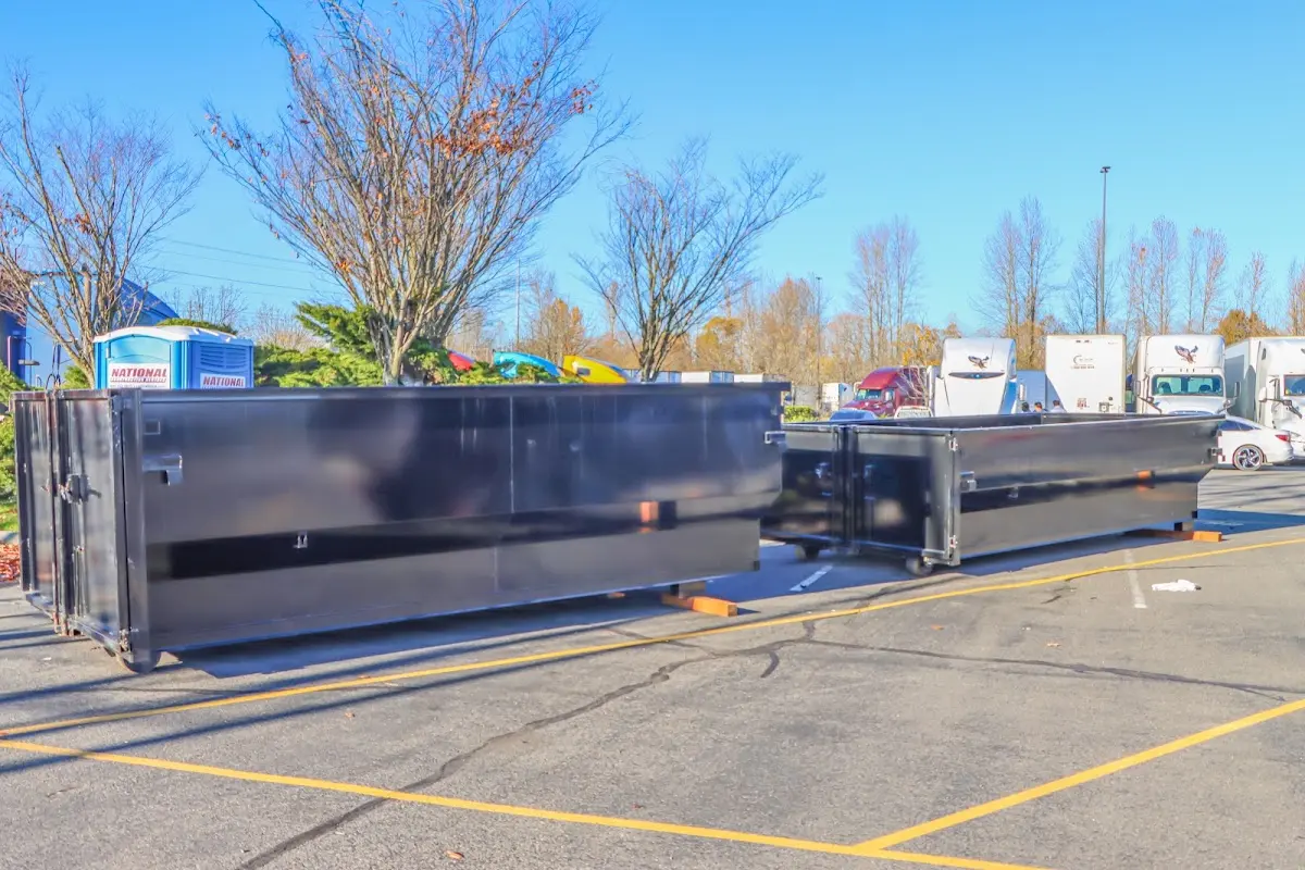 Professional dumpster rental service with roll-off container on residential driveway in Santa Monica